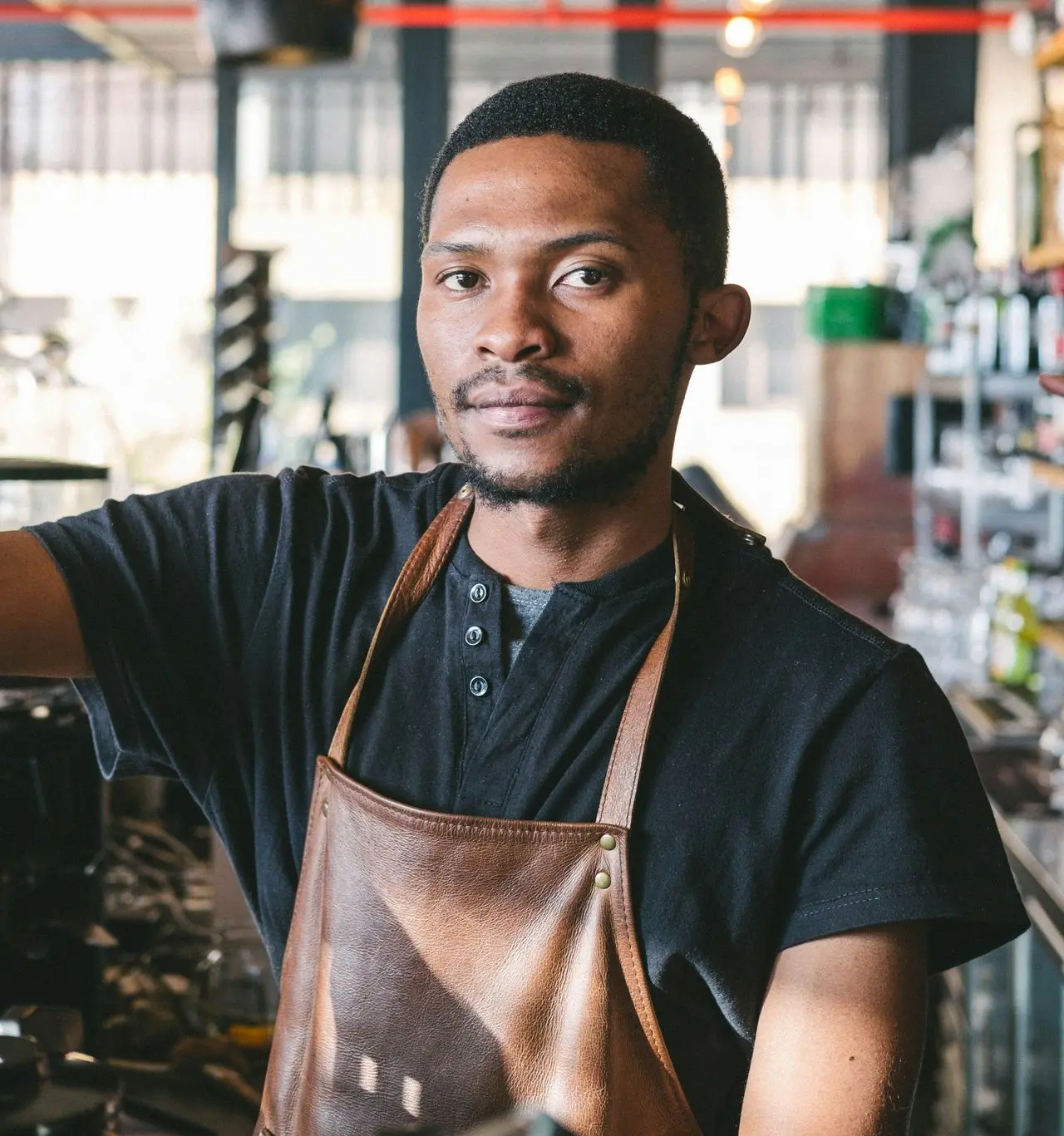 man wearing brown apron